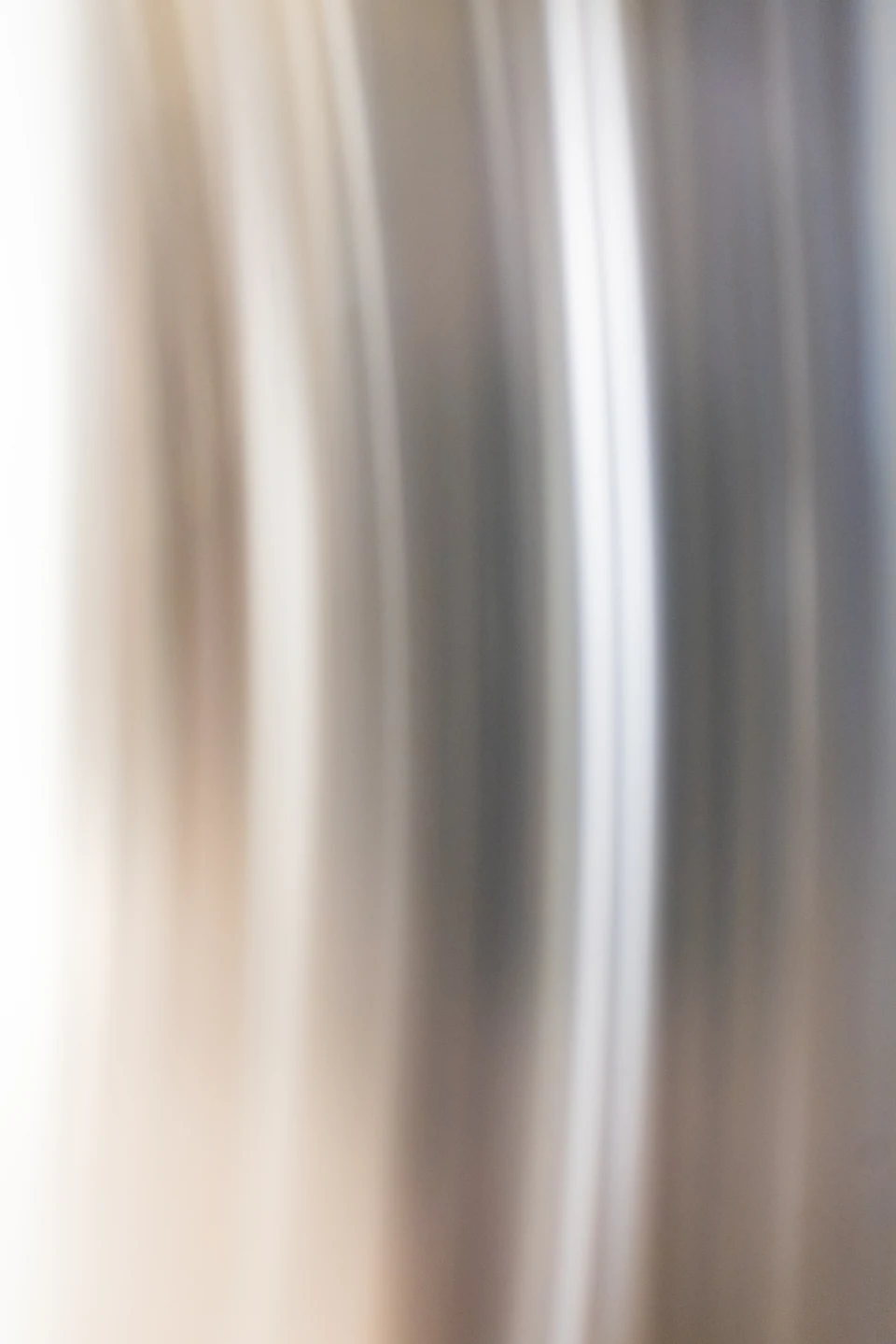 Pale vertical bands dissolve into a soft architectural abstraction.
