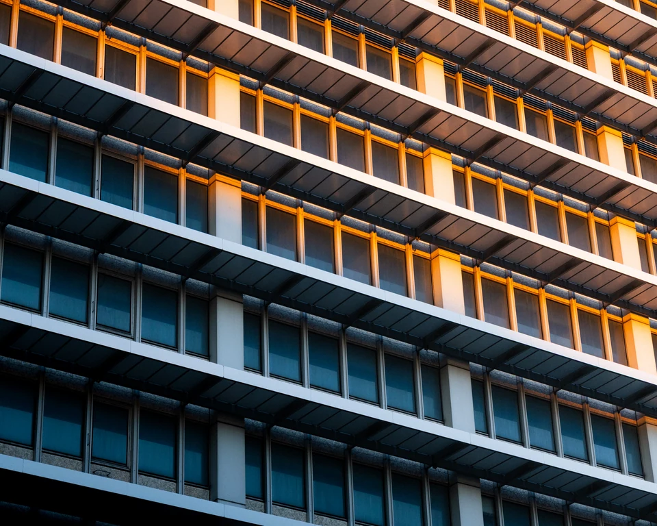Repeating windows catch bands of warm evening light.